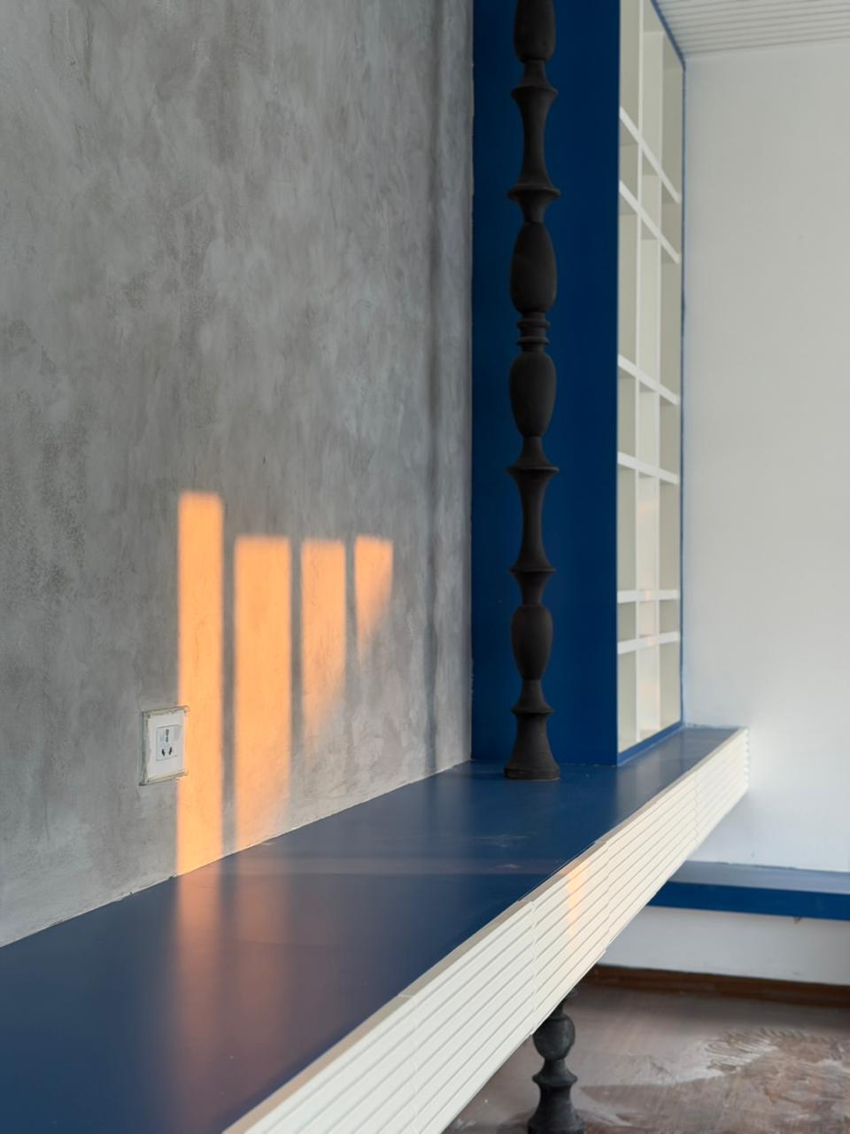 Layered Luxe grey cement-effect textured wall detail
